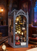 Steampunk book nook kit with clock face and train model glowing with warm LED light