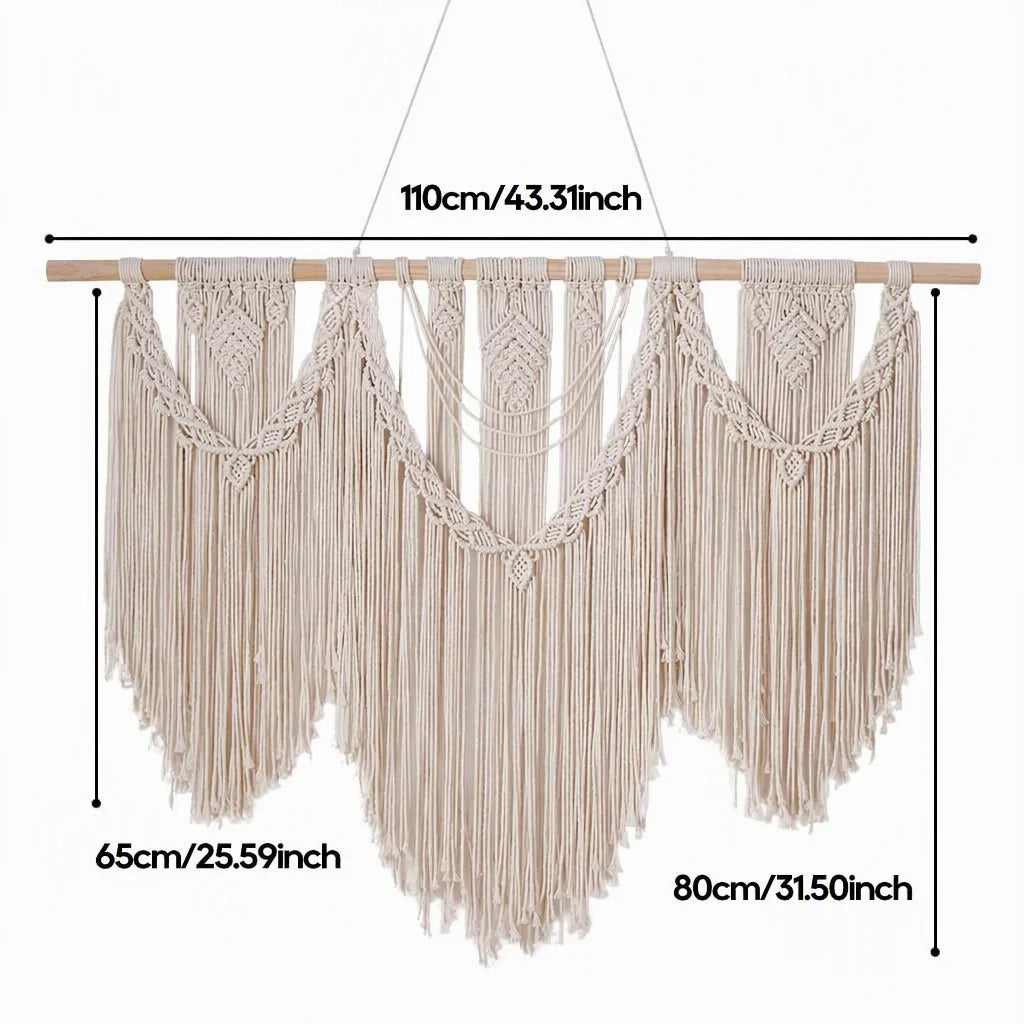 Cream cotton macrame wall hanging with wooden dowel and heart-like braided motifs with long fringe