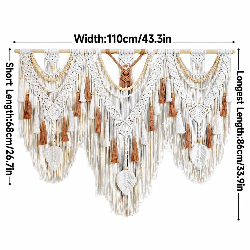 Cream macrame wall hanging with wooden rod, heart-shaped center motif, tan tassels and fringe