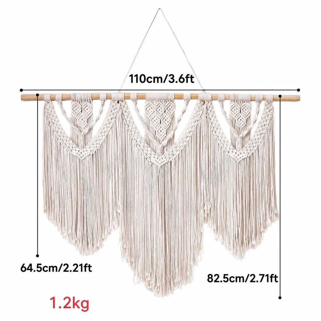 Cream cotton macrame wall hanging with wooden dowel and centered chevron motifs with long fringe