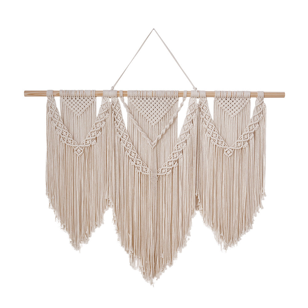 Cream cotton macrame wall hanging with wooden dowel and long fringe with geometric V motifs