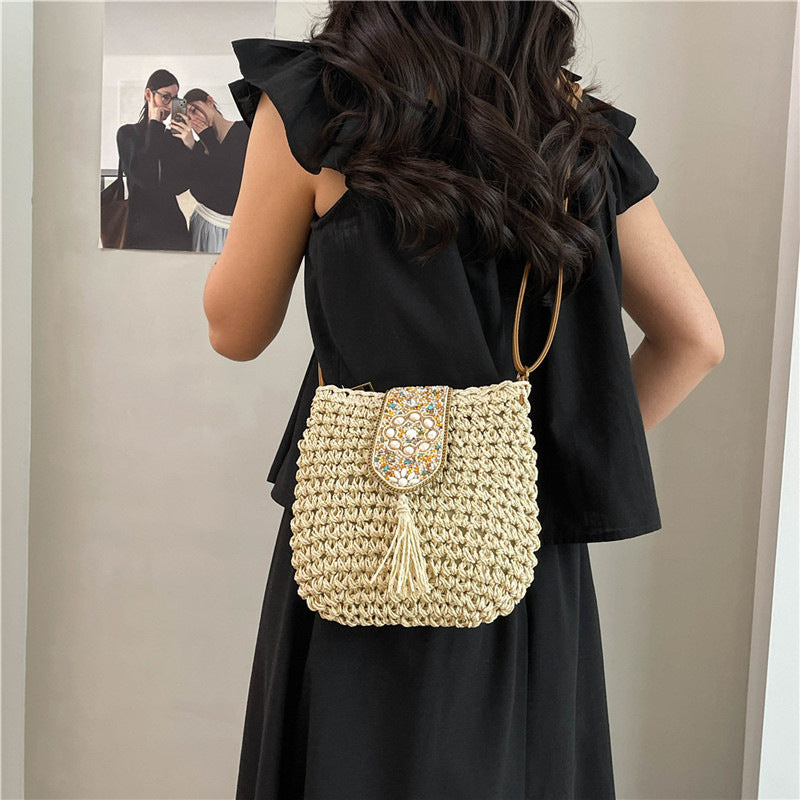 Beige straw crochet crossbody bag with beaded flap and long tassels